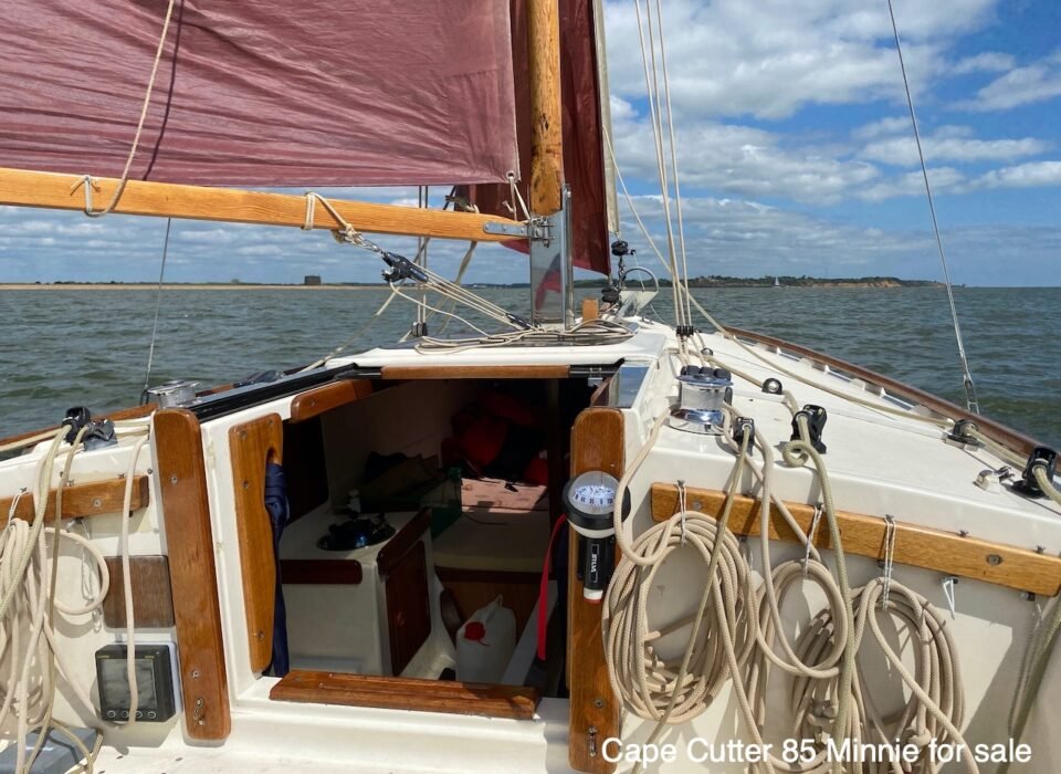 Minnie's halyards and sheets are organised on a modern 'pin rail'.